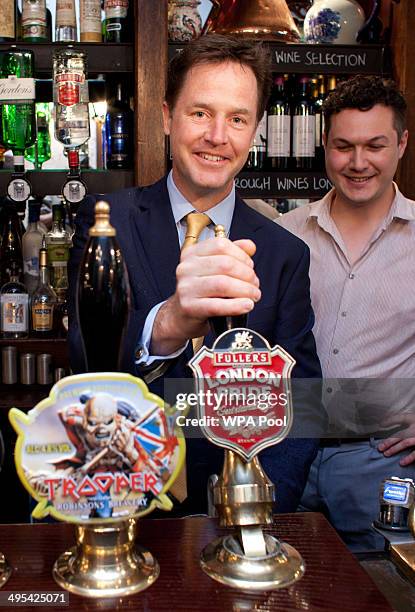 Deputy Prime Minster Nick Clegg pulls a pint at the Queens Head Pub during a brief visit on June 3, 2014 in Soho, London, England. The pair announced...