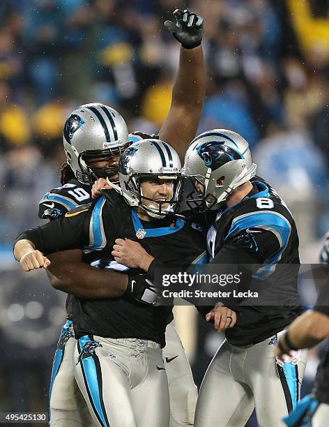 Graham Gano of the Carolina Panthers celebrates the game winning field goal with teammates Chris Scott and Brad Nortman, defeating the Indianapolis...