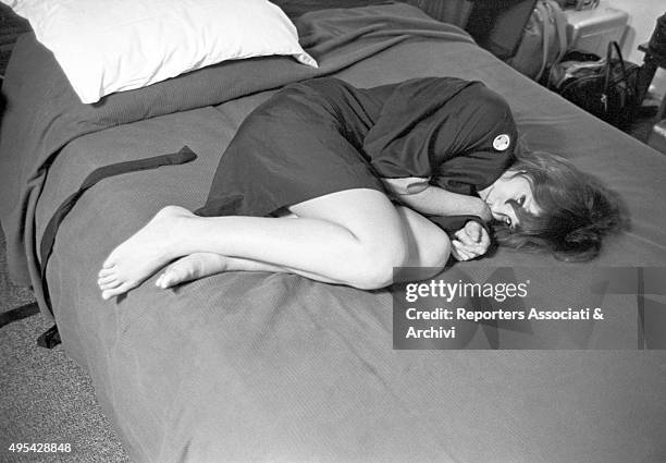 American actress Lee Grant crouched up on the sofa on the set of the film In the Heat of the Night. 2nd January 1968