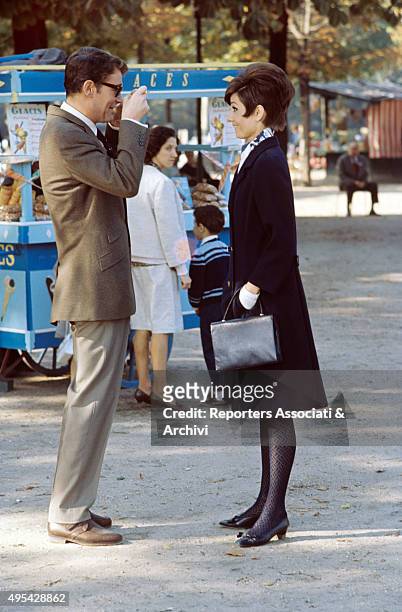 Irish actor Peter O'Toole taking a photo of British actress Audrey Hepburn in the film How to Steal a Million. 1966