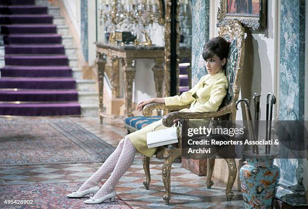 British actress Audrey Hepburn sitting on an old chair in the film How to Steal a Million. 1966