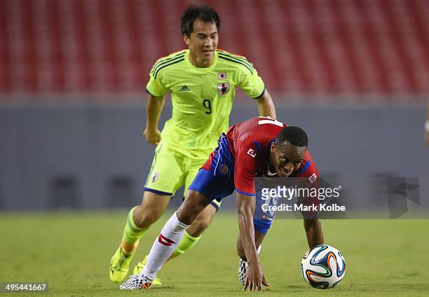 Junior Diaz of Costa Rica and Shinji Okazaki of Japan compete for the ball during the International Friendly Match between Japan and Costa Rica at...