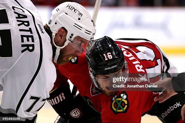 Jeff Carter of the Los Angeles Kings faces off against Marcus Kruger of the Chicago Blackhawks during Game Seven of the Western Conference Final in...