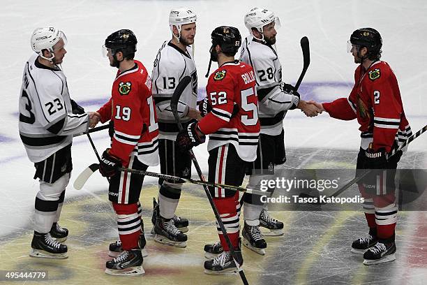 Jonathan Toews, Brandon Bollig and Matt Greene of the Chicago Blackhawks shake hands with Dustin Brown, Kyle Clifford and Jarret Stoll of the Los...