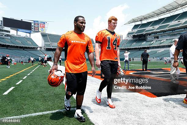 Andy Dalton and Giovani Bernard of the Cincinnati Bengals walk off the field following an organized team activity workout at Paul Brown Stadium on...