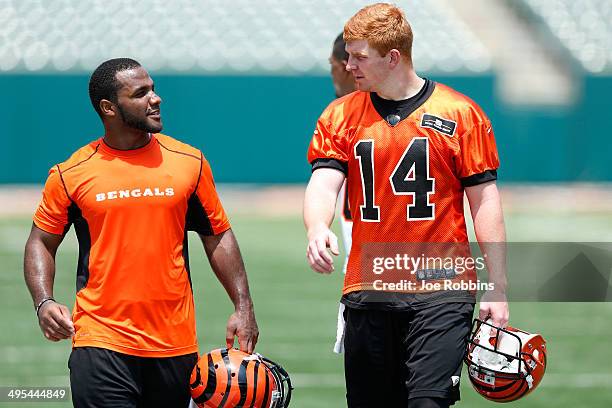 Andy Dalton and Giovani Bernard of the Cincinnati Bengals walk off the field following an organized team activity workout at Paul Brown Stadium on...