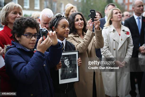 Two pupils from St Clement Danes Schools, Omar ait el Caid and Amina Douglas watch with others as the former leader of the Labour Party Neil Kinnock...