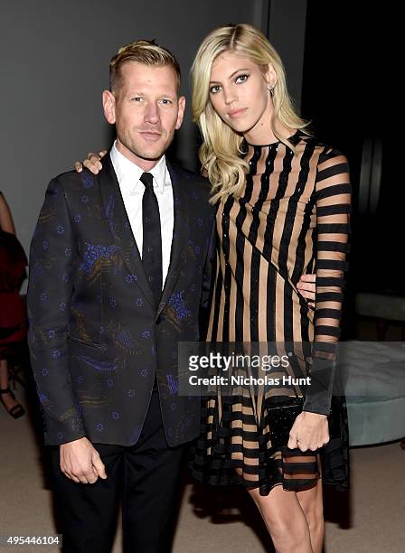 Designer and previous winner Paul Andrew and model Devon Windsor attend the 12th annual CFDA/Vogue Fashion Fund Awards at Spring Studios on November...