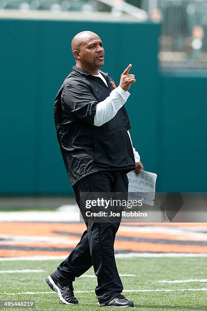 Offensive coordinator Hue Jackson of the Cincinnati Bengals looks on during an organized team activity workout at Paul Brown Stadium on June 3, 2014...