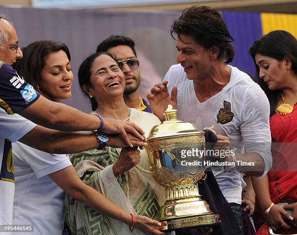 West Bengal Chief Minister Mamata Banerjee with Kolkata Knight Riders owners Shah Rukh Khan and Juhi Chawla holding the champions trophy during...