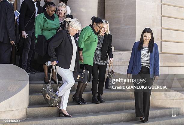 Reeva Steenkamp's mother June and South African ruling party African National Congress women league spokesperson Jacqui Mofokeng embrace as they...