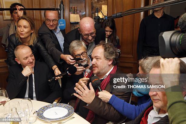 French author Mathias Enard answers journalists' questions next to Goncourt Academie members French authors Philippe Claudel and Regis Debray at the...