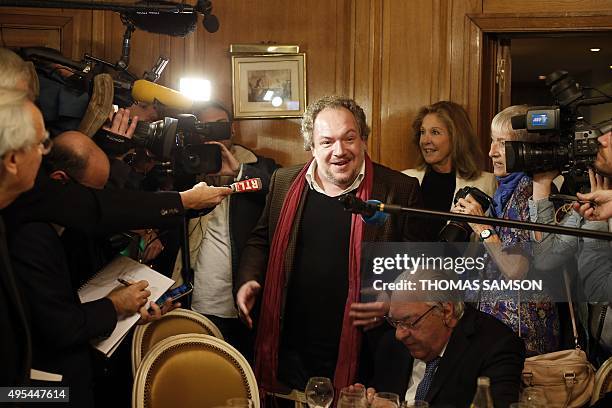 French author Mathias Enard answers journalists' questions at the Drouant restaurant in Paris after he was awarded with France's top literary prize,...