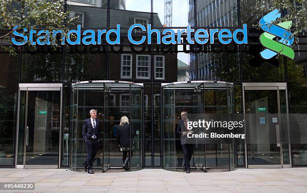 Visitors leave the headquarters of Standard Chartered Plc in London, U.K. On Tuesday, Nov. 3, 2015. Standard Chartered Plc dropped the most in more...