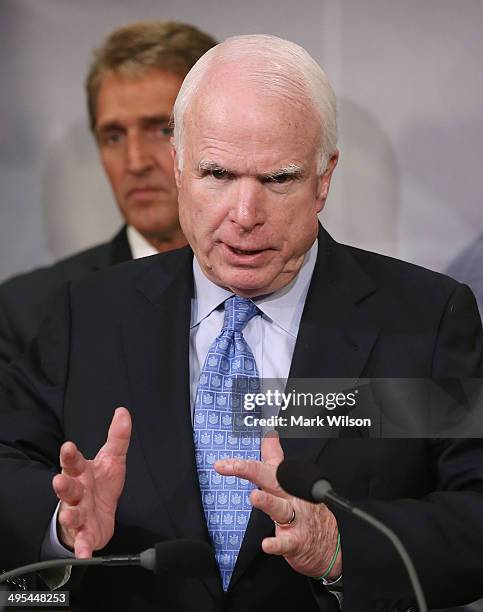 Sen. John McCain speaks while flanked by Sen. Jeff Flake during a news conference on veterans affairs on Capitol Hill, June 3, 2014 in Washington,...