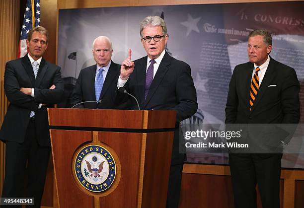 Sen. Tom Coburn speaks about veterans while flanked by Sen. Jeff Flake , Sen. John McCain and Sen. Richard Burr , during a news conference on Capitol...