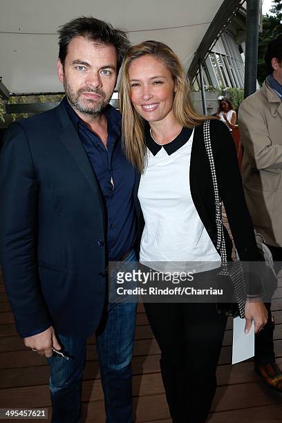 Actors Clovis Cornillac and his wife Lilou Fogli attend the Roland Garros French Tennis Open 2014 - Day 10 on June 3, 2014 in Paris, France.