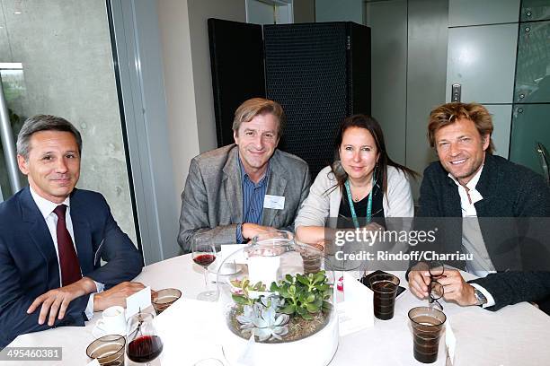 Of the Monnaie of Paris Christophe Beaux, journalists Eric Revel, guest and Laurent Delahousse pose at France Television french chanels studio whyle...