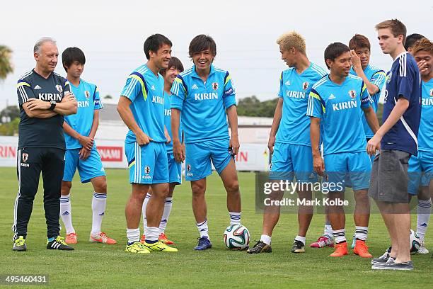 Japan head coach Alberto Zaccheroni watches on as Shinji Okazaki, Yasuhito Endo and Keisuke Honda share a joke as they pose for pictures with...