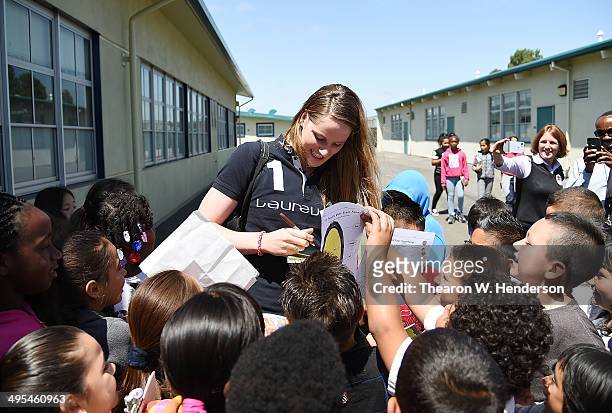 Winner of the Laureus World Sports Award for a female athlete and four-time Olympic gold medalist Missy Franklin signs autographs for the students...