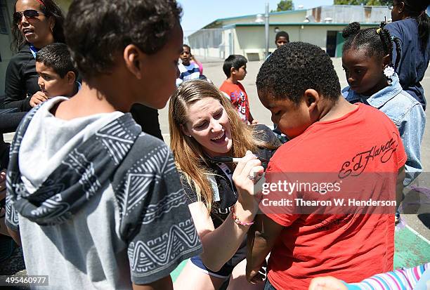 Winner of the Laureus World Sports Award for a female athlete and four-time Olympic gold medalist Missy Franklin signs autographs for the students...