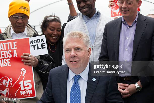 Seattle Mayor Ed Murray pauses while signing a bill that raises the city's minimum wage to $15 an hour on June 3, 2014 in Seattle, Washington. The...