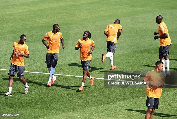 Ivory Coast's footballers warm up during a training session at the Toyota Stadium in Frisco, Texas, on June 3 on the eve of their World Cup...