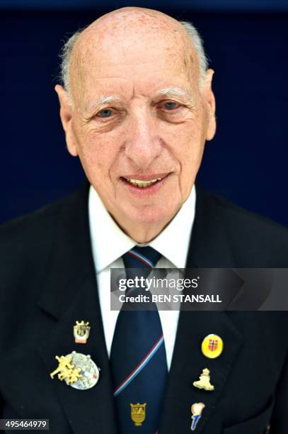 Day veteran with the Royal Artillery, Ron Spencer poses for pictures in Basildon, Essex on June 3, 2014 before embarking on a trip to France to...