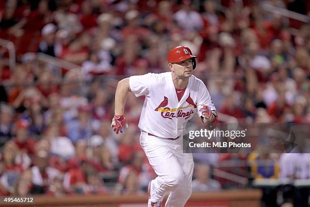 Matt Holliday of the St. Louis Cardinals runs to first base for his 45th consecutive game on-base streak during an MLB game against the Milwaukee...