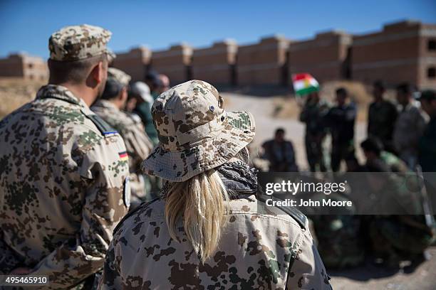 German medics watch as Kurdish Peshmerga forces learn battlefield first aid techniques during a medical training session on November 3, 2015 in...