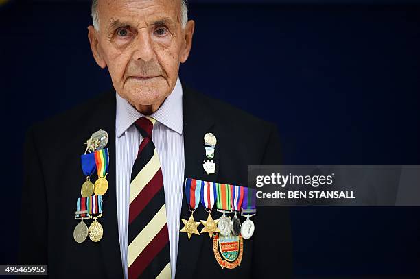 Veteran Private Owen Butcher poses for pictures in Basildon, Essex on June 3, 2014 before embarking on a trip to France to commemorate the 70th...