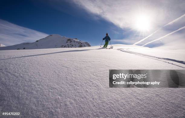 skiing in the afternoon - heli skiing stock pictures, royalty-free photos & images