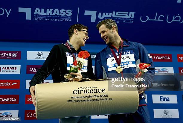 Mitchell Larkin of Australia and David Plumber of USA celebrates on the podium after the Men's 50m Backstroke final during day two of the FINA World...