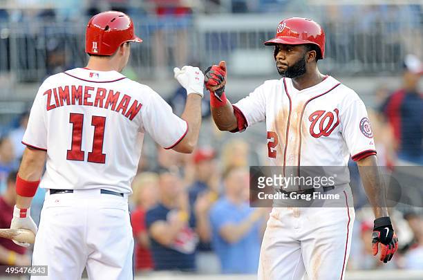 Denard Span of the Washington Nationals celebrates with Ryan Zimmerman after scoring in the third inning against the Philadelphia Phillies at...