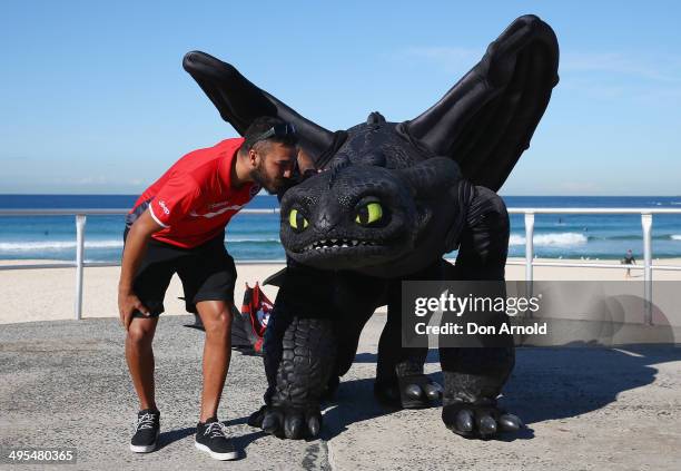 St George-Illawarra NRL player Dylan Farrell gives Toothless the Dragon a kiss at a "How To Train Your Dragon 2" Photo Call at Bondi Beach on June 4,...