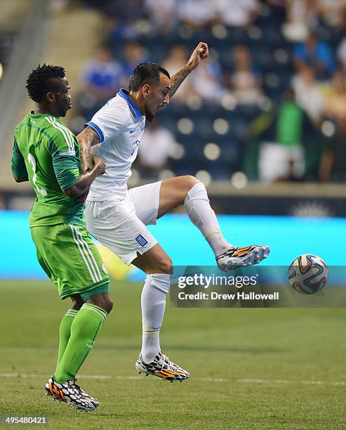 Kostas Mitroglou of Greece holds off Joseph Yobo of Nigeria during an international friendly match at PPL Park on June 3, 2014 in Chester,...