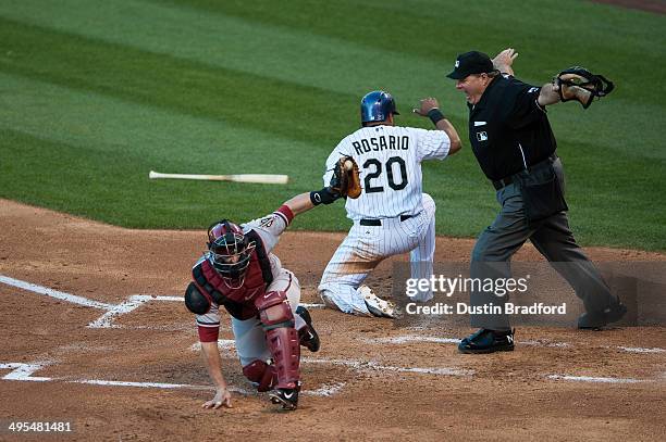 Home Plate umpire Jerry Layne calls Wilin Rosario of the Colorado Rockies safe despite an apparent tag by Miguel Montero of the Arizona Diamondbacks...