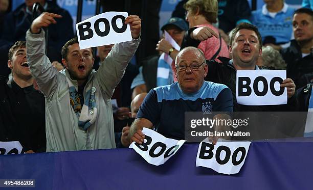 Manchester City fans holds up 'boo' signs the UEFA Champions League Group D match between Sevilla FC and Manchester City FC at Estadio Ramon Sanchez...