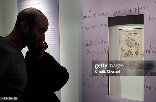 Visitor looks at a drawing by Leonardo da Vinci during the exhibition "Leonardo da Vinci, il Genio - The secrets of the Codex Atlanticus unveiled" at...