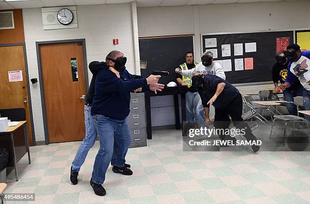 An "active shooter" is tackled as he attacks a classroom during ALICE training at the Harry S. Truman High School in Levittown, Pennsylvania, on...