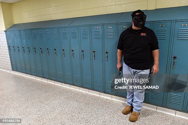 Trainer acting as an "active shooter" lines up to attack a classroom during ALICE training at the Harry S. Truman High School in Levittown,...