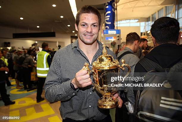 All Blacks captain Richie McCaw arrives back home with the Rugby World Cup trophy at the Auckland Airport in Auckland on November 04, 2015. The New...
