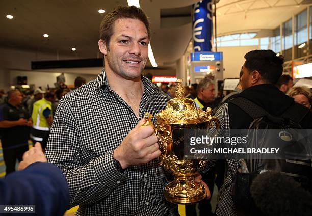 All Blacks captain Richie McCaw arrives back home with the Rugby World Cup trophy at the Auckland Airport in Auckland on November 04, 2015. The New...