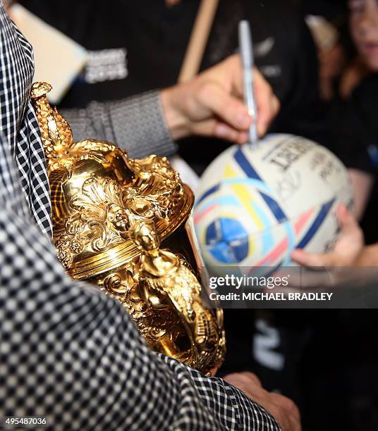 All Blacks captain Richie McCaw arrives back home with the Rugby World Cup trophy at the Auckland Airport in Auckland on November 04, 2015. The New...