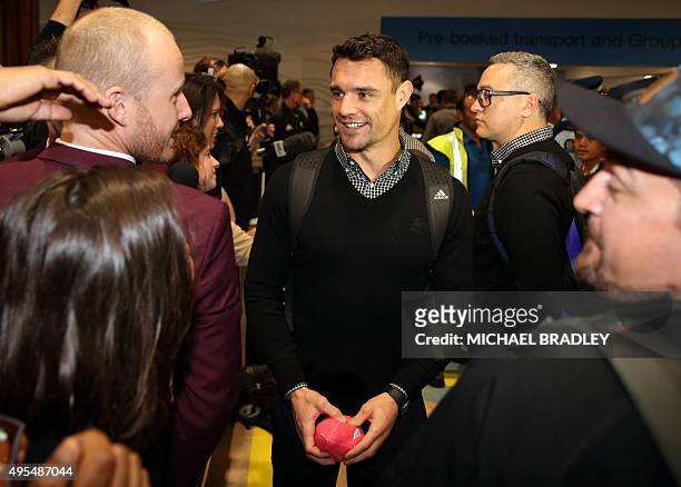 All Blacks Dan Carter arrives back home with the Rugby World Cup trophy at the Auckland Airport in Auckland on November 04, 2015. The New Zeland All...