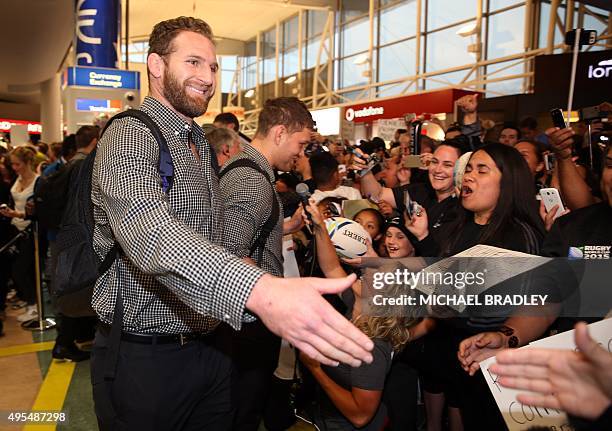 All Blacks Kieran Read arrives back home with the Rugby World Cup trophy at the Auckland Airport in Auckland on November 04, 2015. The New Zeland All...