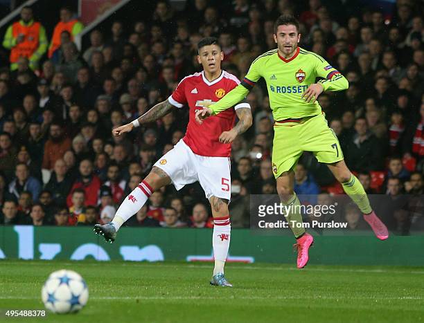 Marcos Rojo of Manchester United in action with Zoran Tosic of CSKA Moscow during the UEFA Champions League match between Manchester United and CSKA...