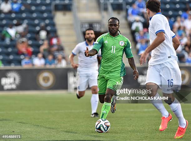 Nigerian national team midfielder Victor Moses moves the ball past Greek midfielder Lazaros Christodoulopoulos during a World Cup preparation...