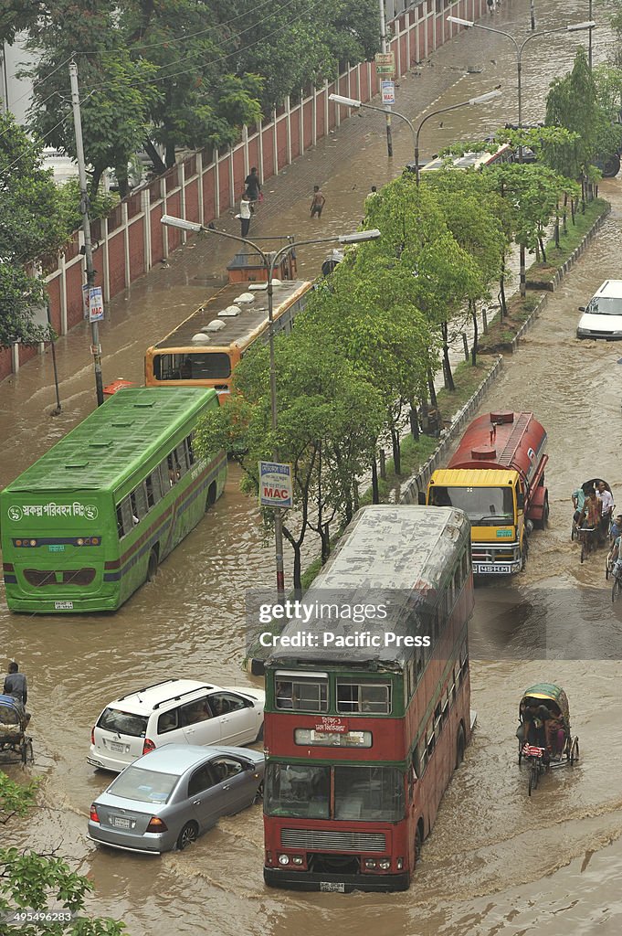 Razarbag Road in Dhaka is submerged by flood water following...