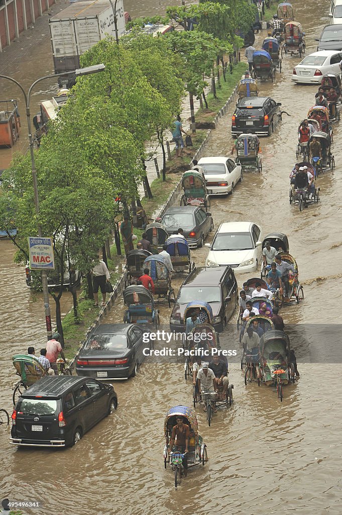 Razarbag Road in Dhaka is submerged by flood water following...